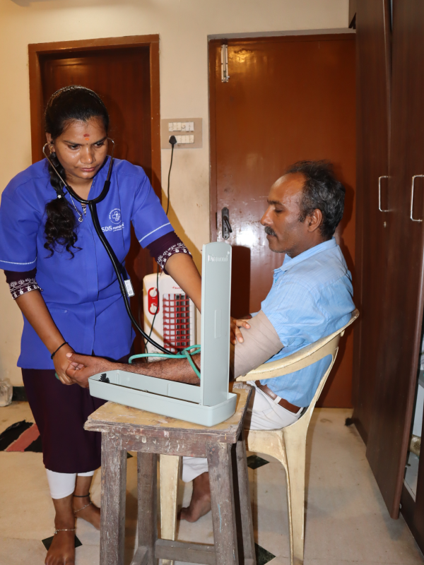 female nurse taking Bloodpressure from patient with care